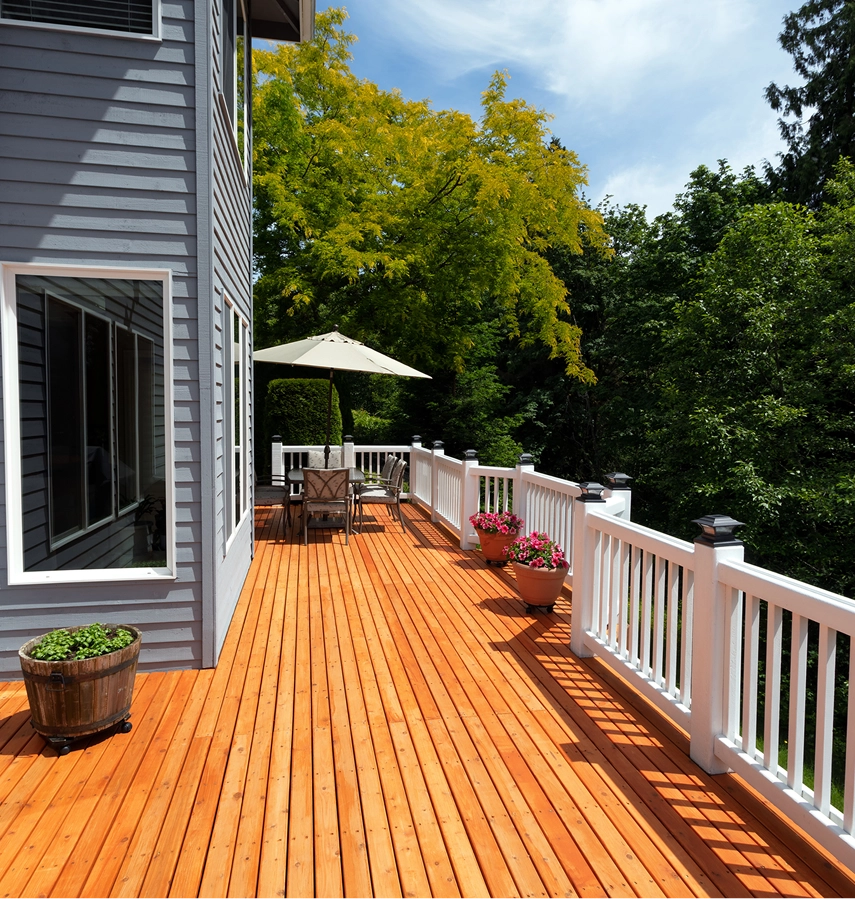 Spacious wooden deck with outdoor furniture
