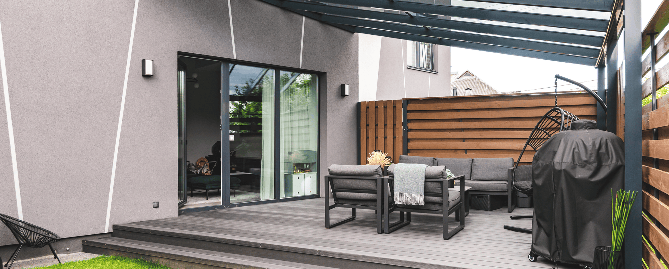 Modern patio with outdoor seating and grill.